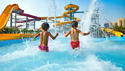 Families enjoying water attractions at a Dubai water park Families enjoying water attractions at a Dubai water park